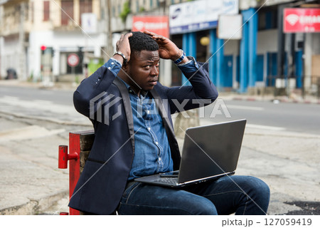 portrait of young man with laptop. portrait of young man with laptop. 127059419