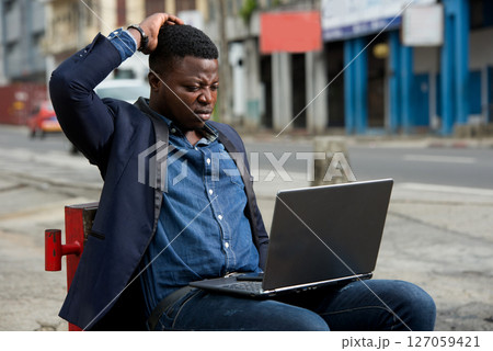 portrait of young man with laptop. portrait of young man with laptop. 127059421