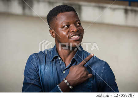 young businessman pointing finger aside 127059797