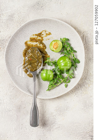 a spoon with tkemali sauce, on a plate, with cherry plum and mint, top view, no people, a spoon with tkemali sauce, on a plate, with cherry plum and mint, top view, no people, 127059902