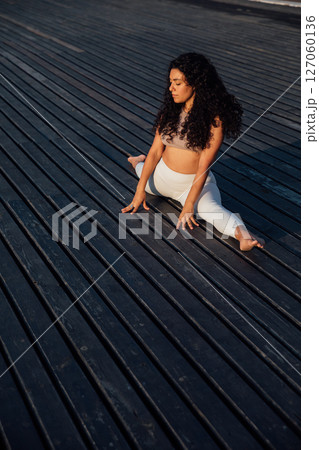 brunette woman doing gymnastics yoga asana brunette woman doing gymnastics yoga asana 127060136