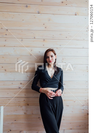 Portrait of a beautiful young brunette girl in black clothes Portrait of a beautiful young brunette girl in black clothes 127060154