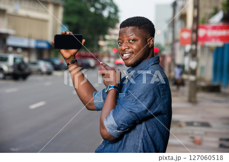 young smiling man presenting the new product showing the hand young smiling man presenting the new product showing the hand 127060518