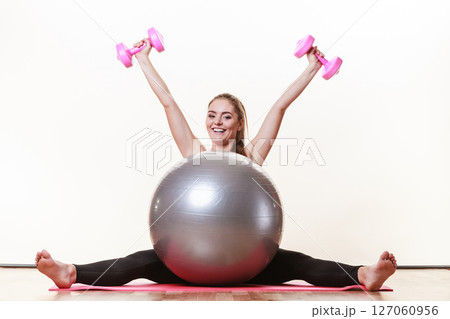 Cheerful brunette exercising. 127060956