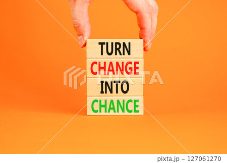 Turn change into chance symbol. Concept words phrase Turn change into chance on beautiful wooden blocks. Beautiful orange paper background. Business Turn change into chance concept. Copy space. 127061270