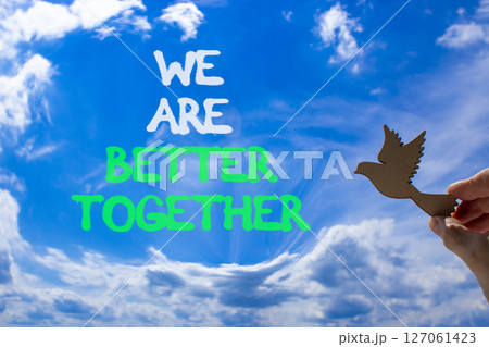 We are better together symbol. Concept words phrase We are better together on beautiful sky. Businessman's hand. Beautiful blue sky background. Business We are better together concept. Copy space. 127061423