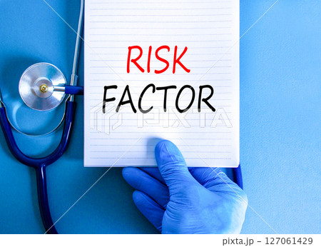 Risk factor symbol. Concept words Risk factor on beautiful white note. Doctor's hand in blue medical glove. Stethoscope. Beautiful blue background. Medical healthy lifestyle risk factor concept. Risk factor symbol. Concept words Risk factor on beautiful white note. Doctor's hand in blue medical glove. Stethoscope. Beautiful blue background. Medical healthy lifestyle risk factor concept. 127061429
