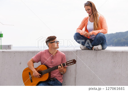 Cheerful couple spending time on coast. 127061681
