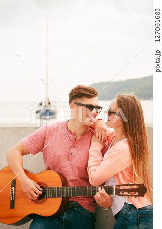Happy couple with guitar outdoor Happy couple with guitar outdoor 127061683
