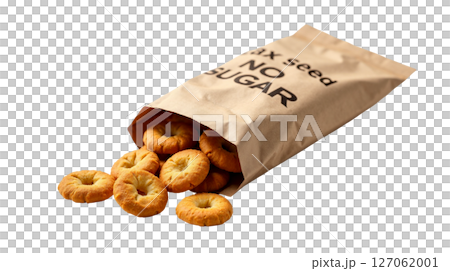 Kraft paper bag of flaxseed crackers is tilted, spilling some crackers onto a white background. The packaging emphasizes no sugar added and highlights its eco-style branding. 127062001