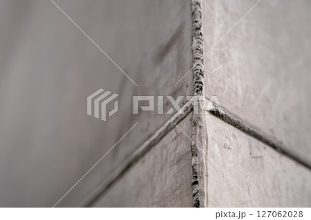 Selective focus on the weld bead and ground joint of stainless steal plats on the Gateway Arch National Park in St. Louis, Missouri 127062028