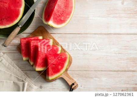 Slices of fresh watermelon on bright rustic wooden table. Copy space 127062361