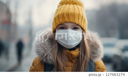 Young Girl in Yellow Hat and Face Mask Looking at Camera Young Girl in Yellow Hat and Face Mask Looking at Camera 127063274