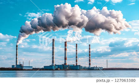 Industrial Smokestacks Release Plumes of Smoke into a Cloudy Sky Industrial Smokestacks Release Plumes of Smoke into a Cloudy Sky 127063380