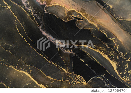Artistic pattern created with alcohol ink on dark surface showcasing elegance and texture Artistic pattern created with alcohol ink on dark surface showcasing elegance and texture 127064704