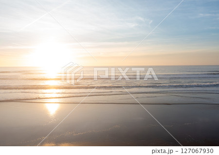 Calm ocean with soft waves reaching shore under 127067930