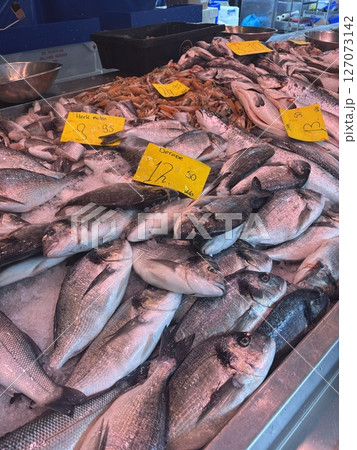 Fresh fish are displayed on ice at a traditional seafood market 127073142