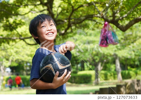 夏の公園でサッカーをする楽しそうな男の子 夏の公園でサッカーをする楽しそうな男の子 127073633