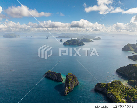 Twin Rocks and Miniloc Island with boats and kayaks. El Nido, Palawan. Philippines. 127074073