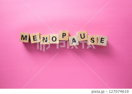 Menopause word written with wooden cubes on pink backgroundMenopause word written with wooden cubes on pink background 127074619