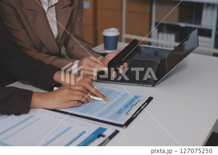 Accounting company provide finance and taxation planning for profitable cash flow, Auditor and accountant team working in office, analyze financial data and accounting record with calculator.Insight 127075250