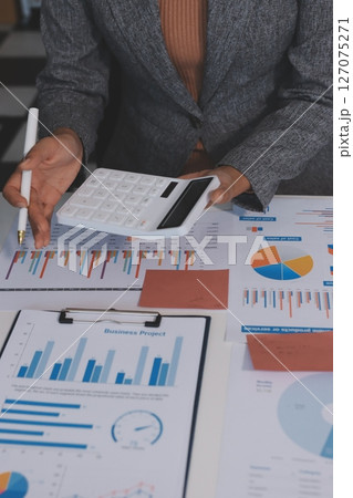 Accounting company provide finance and taxation planning for profitable cash flow, Auditor and accountant team working in office, analyze financial data and accounting record with calculator.Insight 127075271