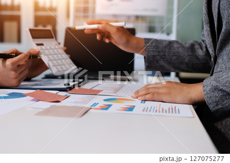 Accounting company provide finance and taxation planning for profitable cash flow, Auditor and accountant team working in office, analyze financial data and accounting record with calculator.Insight 127075277