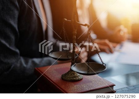 Judge gavel with Justice lawyers having team meeting at law firm background. Concepts of Law and Legal services. Judge gavel with Justice lawyers having team meeting at law firm background. Concepts of Law and Legal services. 127075290