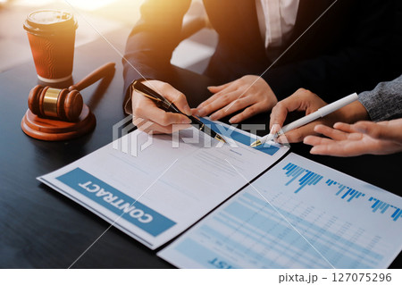 Judge gavel with Justice lawyers having team meeting at law firm background. Concepts of Law and Legal services. 127075296