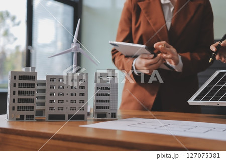 Discussion among businesspeople on the latest developments in solar cell panel technology and Solar Energy Environment city Concept. 127075381