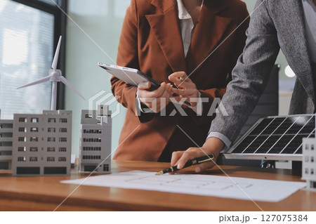 Discussion among businesspeople on the latest developments in solar cell panel technology and Solar Energy Environment city Concept. Discussion among businesspeople on the latest developments in solar cell panel technology and Solar Energy Environment city Concept. 127075384