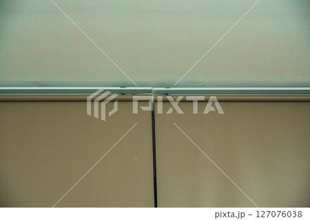Minimalist view of the ceiling and closed window blinds indoors 127076038