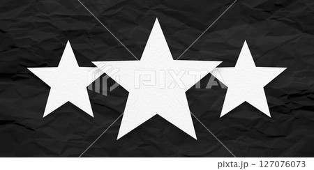 White paper stars, isolated on black crumpled paper background. 127076073