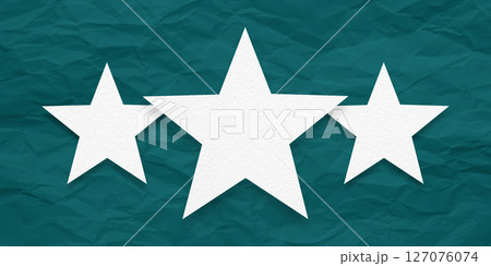 White paper stars, isolated on green crumpled paper background. 127076074