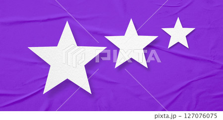 White paper stars, isolated on purple crumpled paper background. 127076075