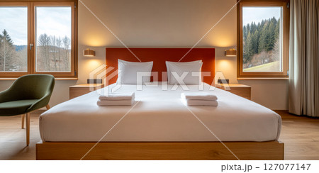 Modern bedroom featuring minimalist design with large windows and scenic forest view 127077147