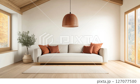 Cozy living room featuring a light gray sofa with orange pillows and a modern pendant lamp Cozy living room featuring a light gray sofa with orange pillows and a modern pendant lamp 127077580