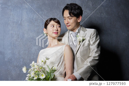 見つめ合う新郎新婦　ポートレート　黒背景 127077593