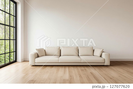 A roomy minimalist living room with a large cream sofa and a calming window view A roomy minimalist living room with a large cream sofa and a calming window view 127077620