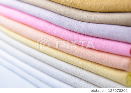 stack of colourful cotton clothes, close up pile of clothing stack of colourful cotton clothes, close up pile of clothing 127078202