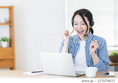 リビングでオンライン英会話をするミドル女性。 リビングでオンライン英会話をするミドル女性。 127078615