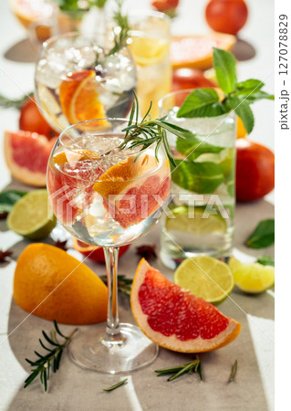 Refreshing summer cocktails with citrus on a white marble table. Refreshing summer cocktails with citrus on a white marble table. 127078829