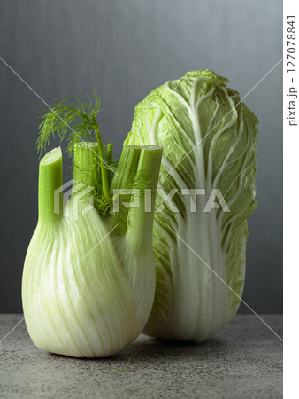 Fresh Chinese cabbage and fennel bulb on a gray background. Fresh Chinese cabbage and fennel bulb on a gray background. 127078841