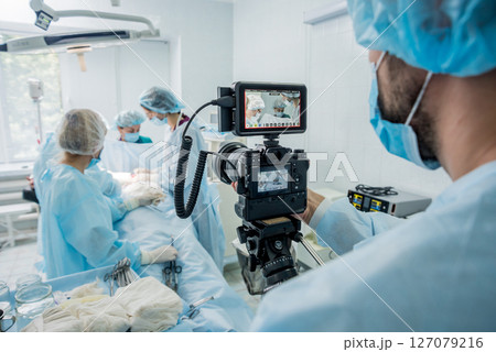 The videographer shoot the surgeon and assistants in the operating room The videographer shoot the surgeon and assistants in the operating room 127079216
