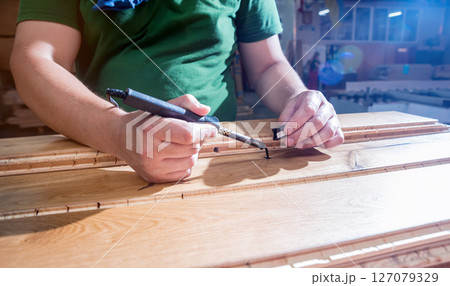 Carpenter with fibreboards at furniture factory workshop. Woodworking industry 127079329