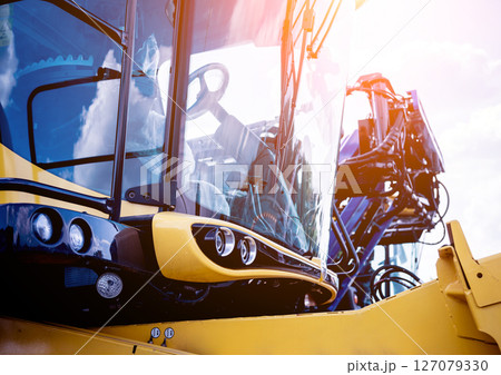 Modern agricultural machinery and equipment. Yellow agricultural harvester. 127079330