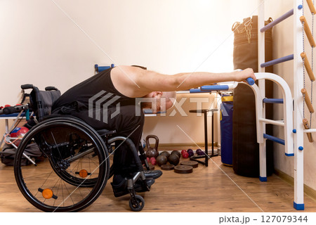 Disabled man training in the gym. Rehabilitation center 127079344