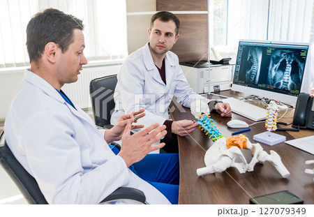 Doctors team having medical council in hospital. Discussing medical issues.  127079349