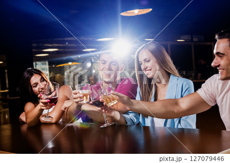 Cheerful friends in the pub. Drinking beer, wine and whisky 127079446