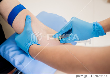Nurse taking blood sample. Medical equipment. Blood test. 127079533